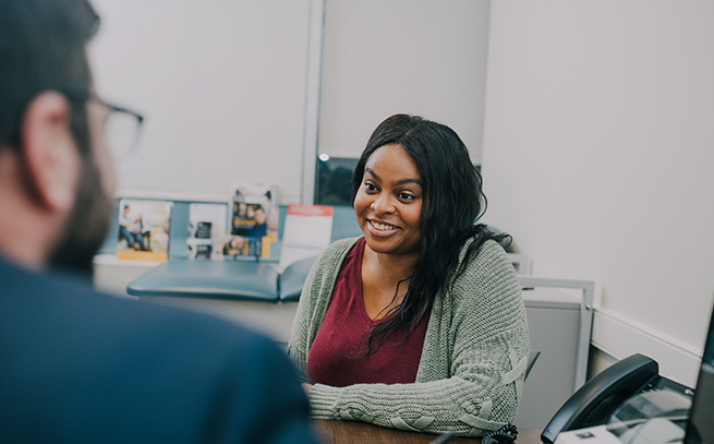 counselor talking with a patient inside an office setting